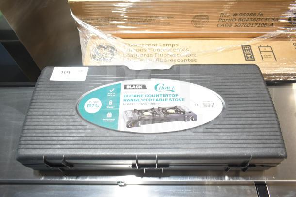 BRAND NEW Choice 472BR215 2-Burner Butane Range in case, 30,000 BTU, brass burner, portable, label visible, minor scratches.