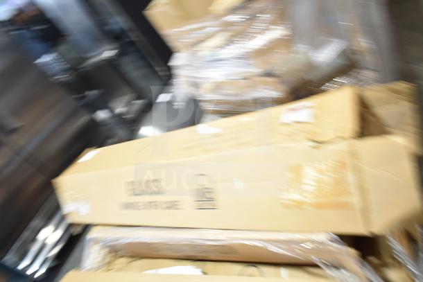 Blurred image of multiple cardboard boxes, some labeled "Fragile," possibly containing fluorescent tube lights. Boxes are slightly damaged.
