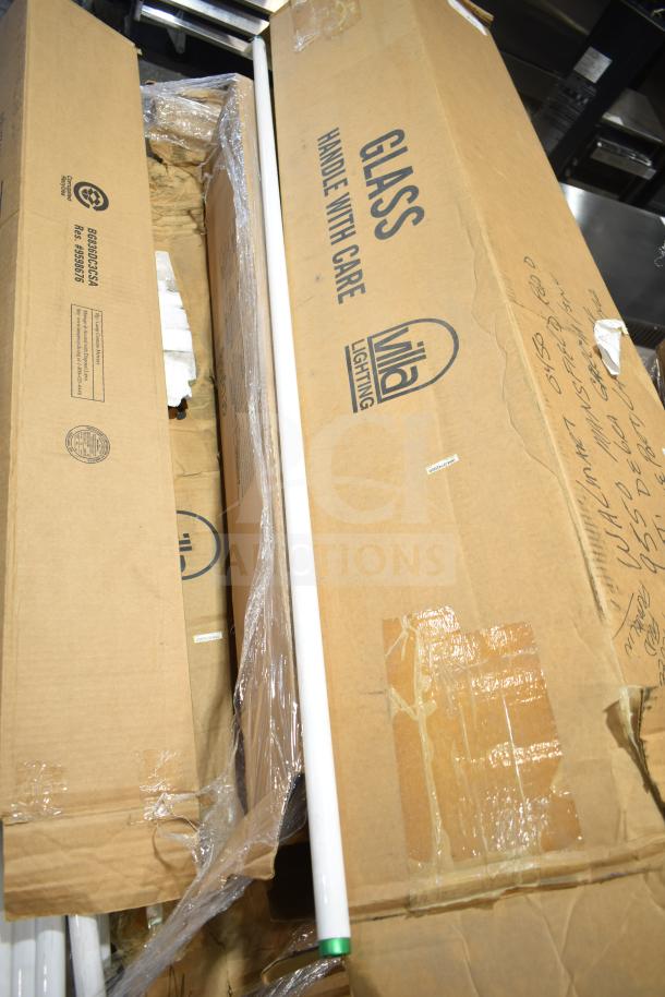 12 new scratch and dent fluorescent tube lights in original packaging, marked "Glass, Handle with Care," by Vila Lighting.