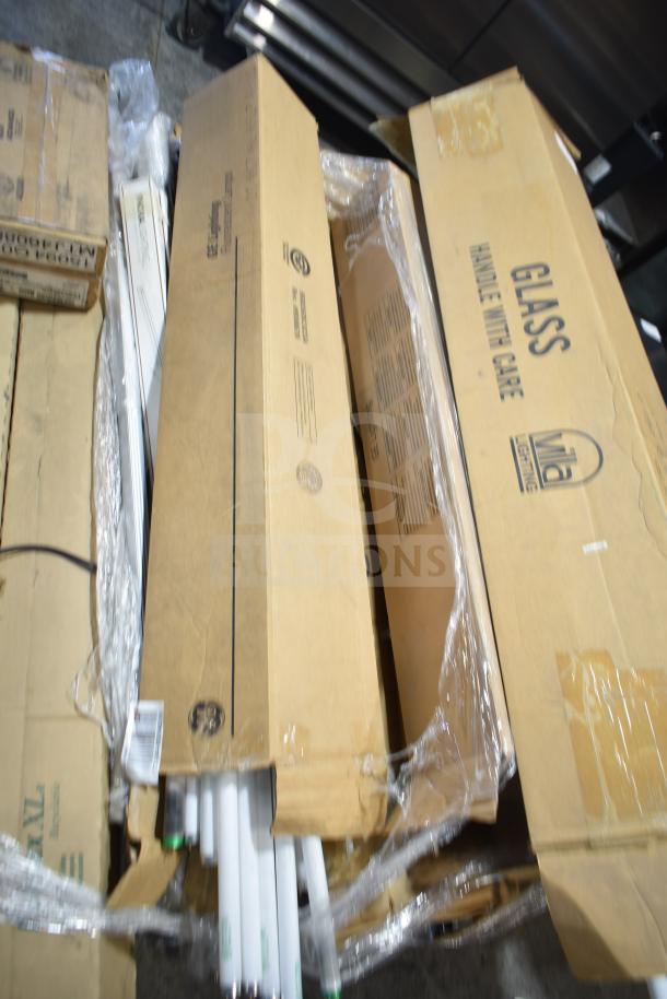 Boxes of 12 brand new scratch and dent fluorescent tube lights, some in original packaging, mixed condition.