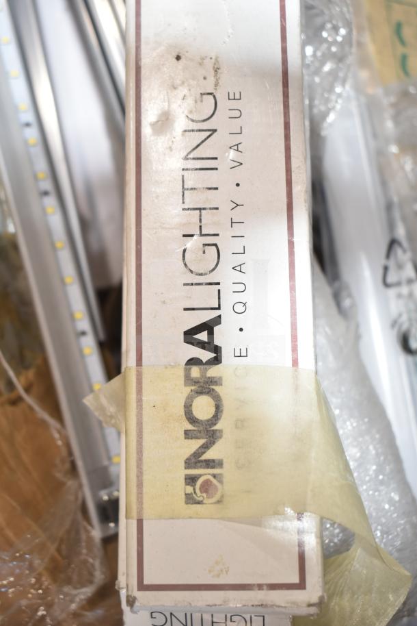 Nora Lighting box with branding, containing new scratch and dent fluorescent tube lights. Box shows signs of wear.