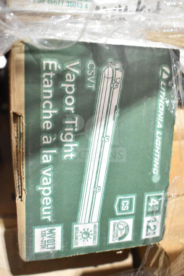 Box of Lithonia Lighting Vapor Tight 4-foot fixtures, labeled "CSVT" and "MVOLT," brand new condition despite scratch and dent.