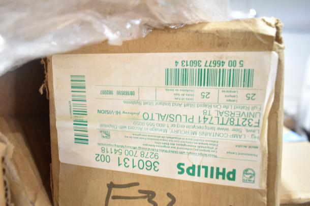 Box of new Philips fluorescent tube lights, model number F32T8/TL741/PLUS/ALTO, visible label with handling instructions.