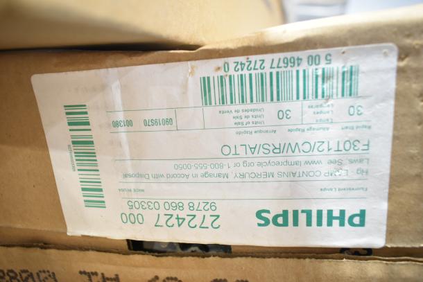 Box containing 20 new Philips fluorescent tube lights, labeled as scratch and dent, with visible product and barcode details.