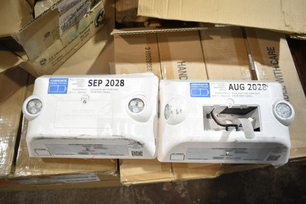 12 new scratch and dent items including GE ballasts and DualLite LED emergency light back boxes with warranty tags.