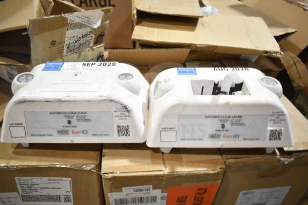 12 new scratch and dent items including GE ballasts and DualLite LED emergency light back boxes. Labels indicate expiry dates August and September 2028.