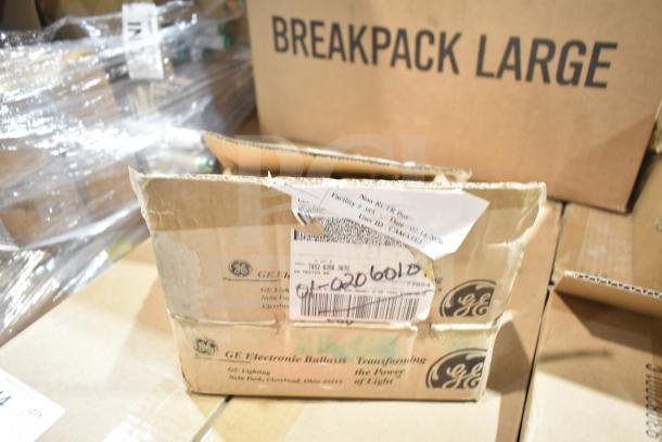 12 new scratch and dent items including GE ballasts and DualLite LED emergency light back box, in original packaging.