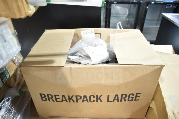 Cardboard box labeled "BREAKPACK LARGE" containing assorted new scratch and dent items, including GE Ballasts and DualLite LED emergency light back box, with visible packaging materials.