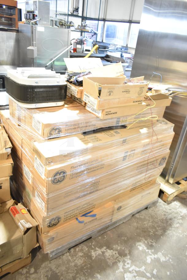 Stack of GE fluorescent lamp boxes, Philips Advance ballasts, and fan in packaging. Items are new, slight cosmetic flaws noted.