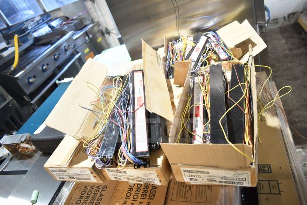 32 new scratch and dent items including ballasts, fan components, Philips/GE fluorescent lights, in boxes, wires visible.