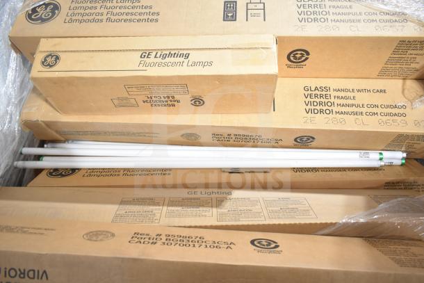10 brand new GE fluorescent tube lights in original packaging. Boxes labeled with handling instructions and product details.