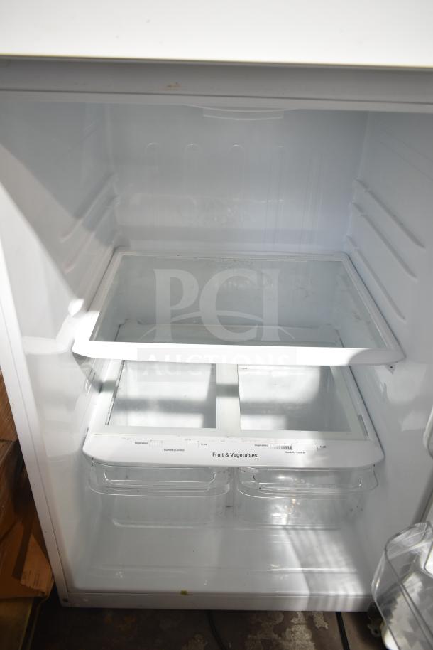 LG LTCS20020W/00 reach-in cooler with freezer, 115V, 1-phase. Interior shelves and crisper drawers visible, good condition.