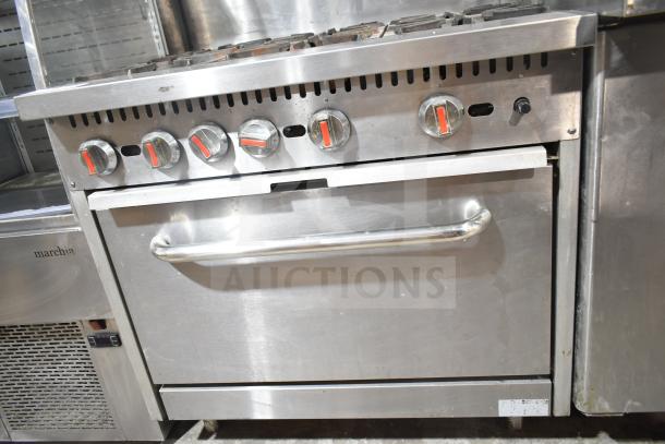 Commercial gas-powered 6-burner range with oven, over shelf, and back splash. Stainless steel, used condition.