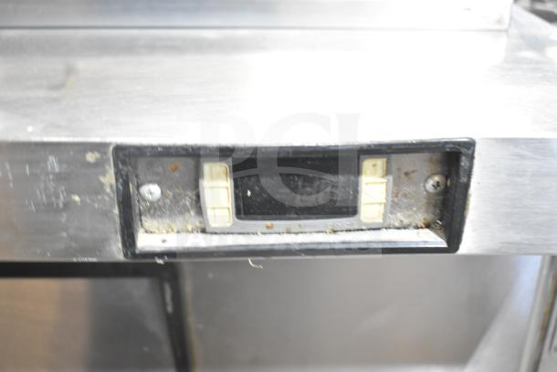 Migali C-SP72-30BT prep table display, shows wear, digital controls visible, stainless steel surface, commercial casters.