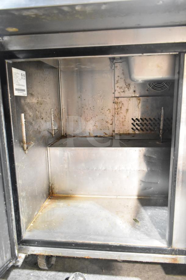 2017 Migali C-SP72-30BT prep table interior showing wear; commercial casters visible, 115V, 1 phase; model tag present.