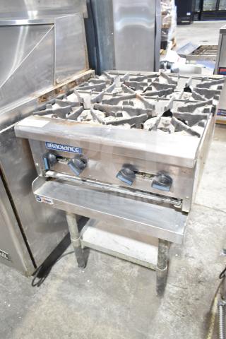 Radiance commercial countertop gas 4-burner range on stand, stainless steel, visible wear, brand logo on front panel.