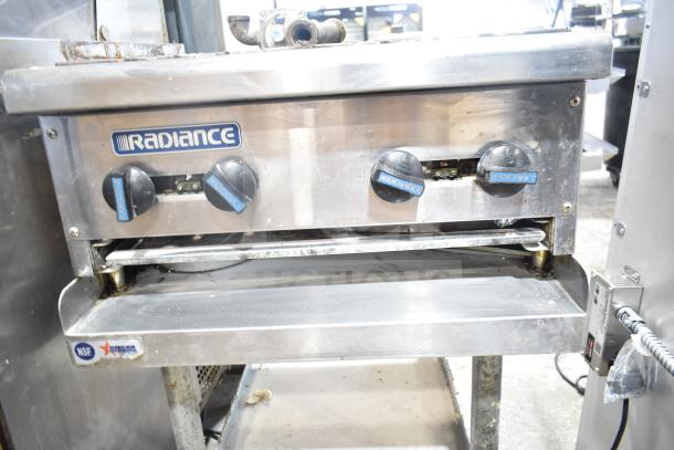 Radiance gas-powered 4 burner range on equipment stand, NSF certified, with user dials, commercial-grade condition.