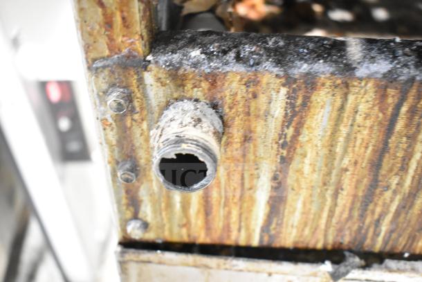 Radiance Commercial Countertop Gas 4 Burner Range in rusty condition, attached to an equipment stand. Features visible corrosion.