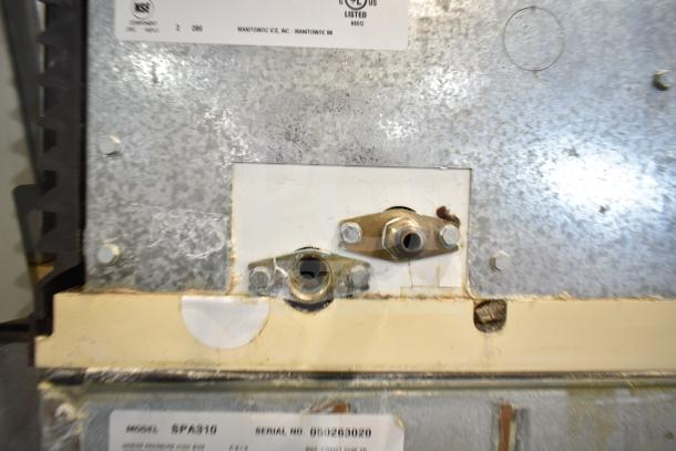 Manitowoc SD0452A Ice Machine Head on Manitowoc SPA310 Dispenser, 115V, 1 Phase. Metal surface shows signs of wear. Model and serial number labels visible.