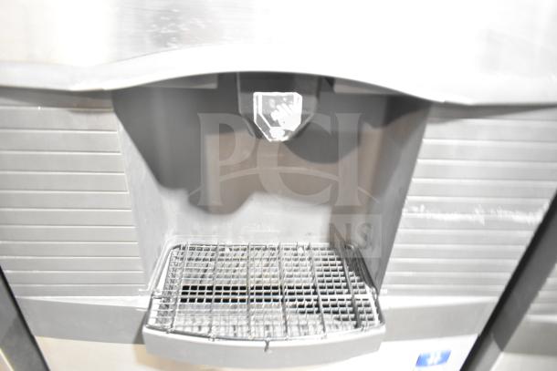 Manitowoc SD0452A ice machine head on SPA310 dispenser, 115V, commercial use, stainless steel finish, in used condition.