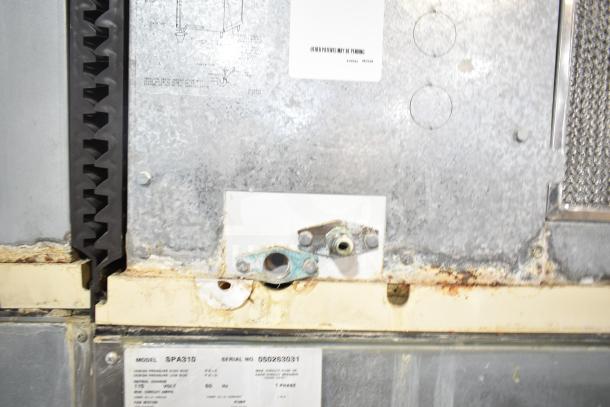 Manitowoc SD0452A ice machine head on SPA310 dispenser, 115V, 1 phase. Visible markings, moderate wear on surface.