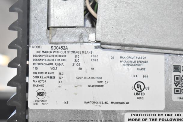 Manitowoc SD0452A ice machine head on a SPA310 hotel dispenser, 115V, 1 phase. Visible label with specs and certifications.