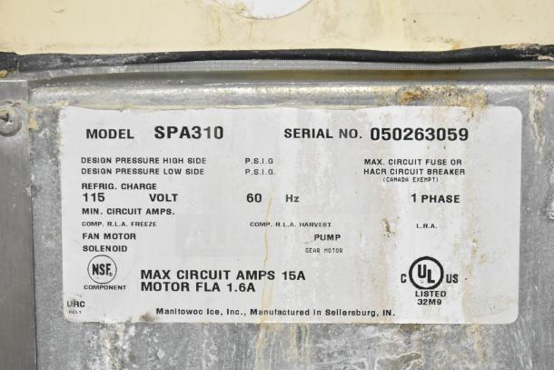 Manitowoc SPA310 ice dispenser label showing model, voltage, and serial number. 115V, 1 phase, 60Hz. 
