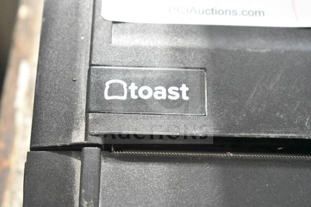 Toast Receipt Printer, black, featuring Toast logo. Visible wear on edges. Ideal for efficient receipt printing.