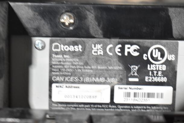 Close-up of Toast Receipt Printer label showing compliance markings, model information, serial number, and MAC address.