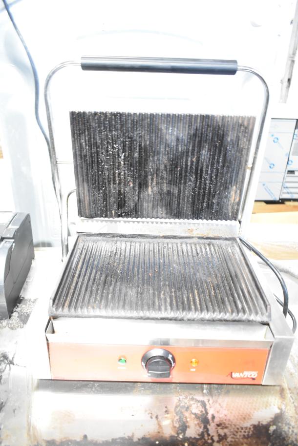 Avantco Countertop Panini Press with ribbed grill plates, temperature control knob, and indicator lights, in used condition.