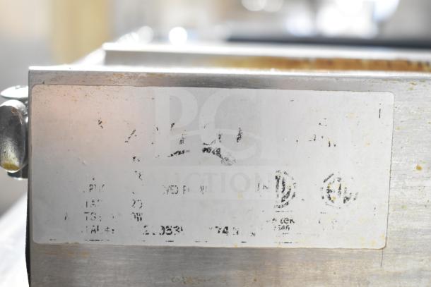 Avantco Countertop Panini Press with a worn metal label, showing faded text and logos, indicative of usage.