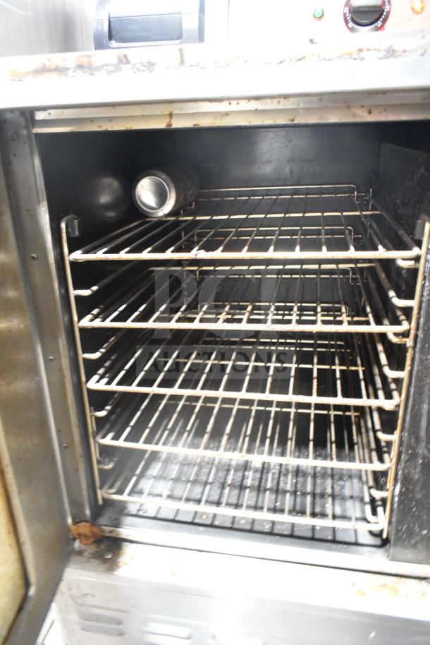 Blodgett commercial gas convection oven, half size, with view-through door and thermostatic controls. Features five racks. Signs of wear visible.