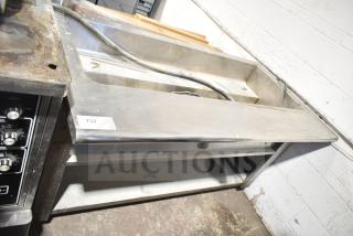 Commercial electric steam table with under shelf, stainless steel, used condition, visible wiring, item tag number 132.
