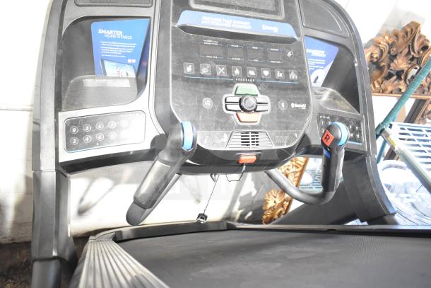Horizon Folding Treadmill, digital display, incline controls, Bluetooth-enabled, visible workout program labels.