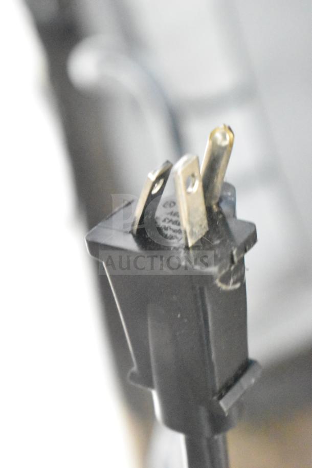Close-up of a power plug for the Horizon Folding Treadmill. Standard three-prong design, slightly worn condition.