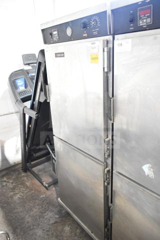 CresCor HU18-671-120 heated holding cabinet, metal finish, on casters, dual doors, visible controls, shows wear.