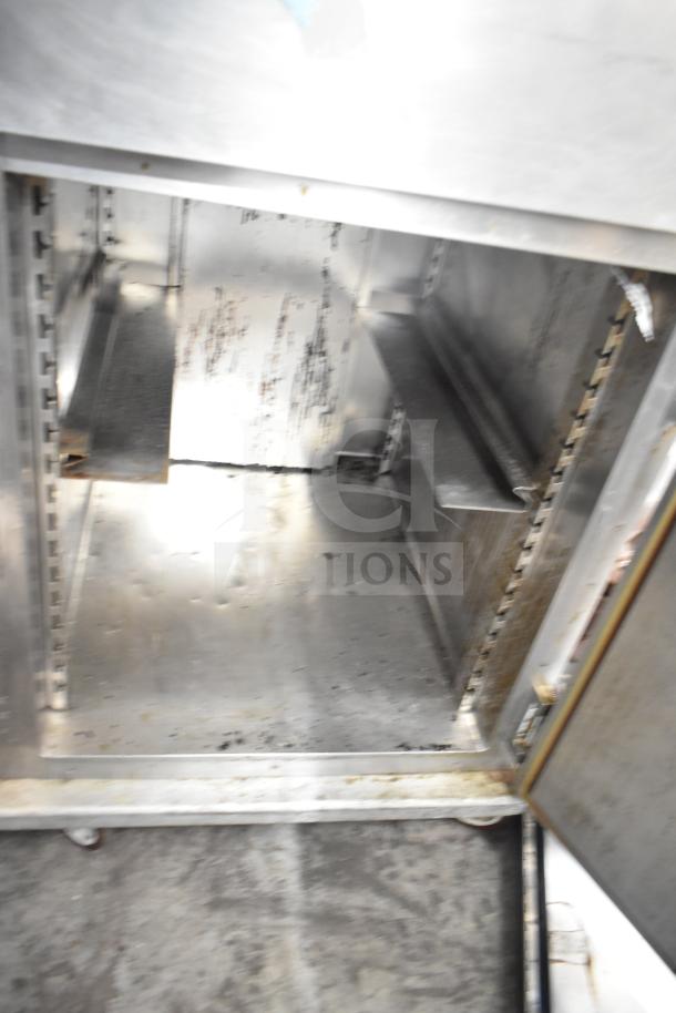 CresCor HU18-671-120 commercial heated holding cabinet on casters, visible shelved interior, shows wear, stainless steel.