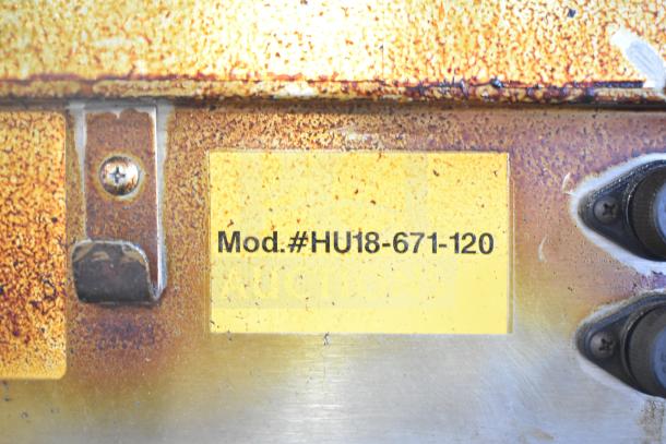 CresCor HU18-671-120 heated holding cabinet label, showing model number on a worn surface with signs of rust.