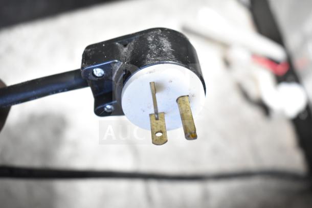 Close-up of Avantco 177PBD3 cappuccino machine plug, showing 120V, 1-phase connection. Black casing with screws visible.