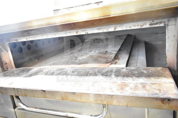 Bakers Pride DS-805 commercial gas pizza oven, single deck, used condition, interior view with stone deck, model markings.