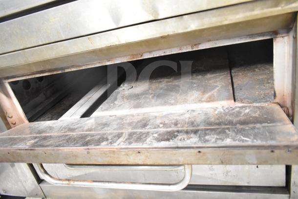 Bakers Pride DS-805 commercial natural gas single deck pizza oven in used condition, showing interior cooking surface.