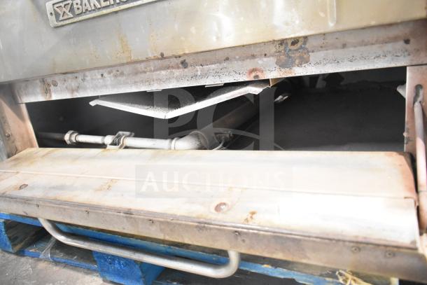 Bakers Pride DS-805 commercial single deck pizza oven, natural gas-powered, visible wear, stainless steel exterior.