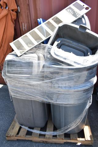 Eight gray poly trash cans, shrink-wrapped on a pallet. Durable construction, ideal for bulk purchase. Some lids visible.