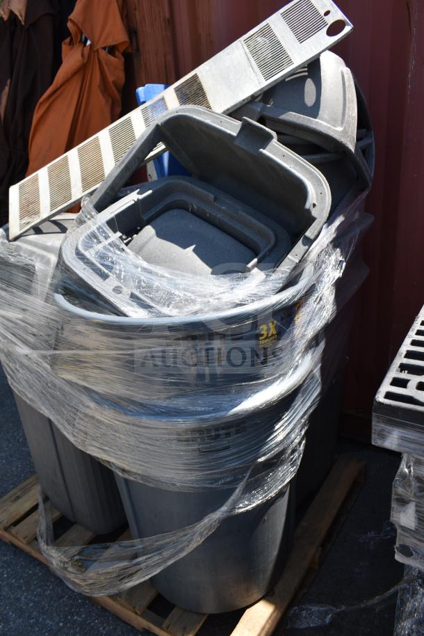 Eight gray poly trash cans, wrapped on a pallet. Durable construction with visible "3X Tougher" label.