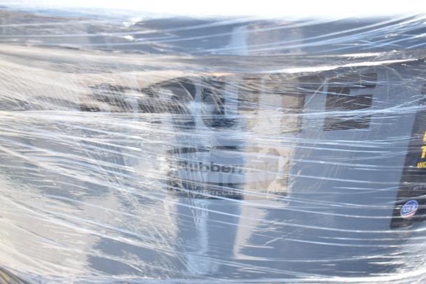 Eight gray Rubbermaid poly trash cans, wrapped in plastic, featuring "Commercial" label. New condition.