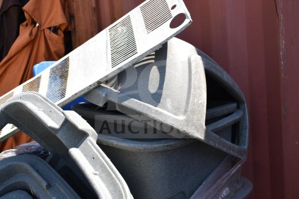 Gray poly trash cans stacked, showing durable material and textured surface. Quantity: 8. Used condition.