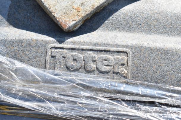 Gray Toter trash can with logo visible, wrapped in plastic. Part of an auction lot of 8. Robust poly material.