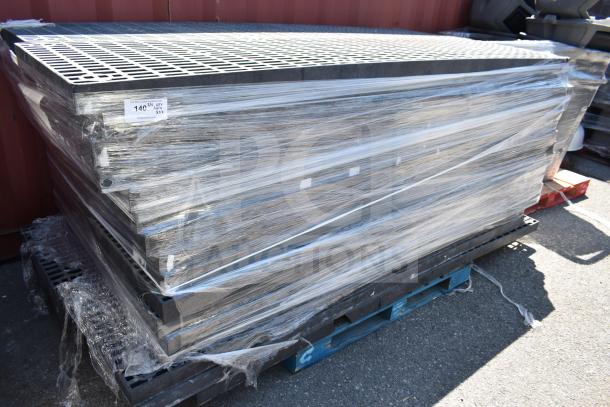 Stacked black poly shelves wrapped in plastic on pallets, 32 units. Tag indicates $140.45 for 15 units.