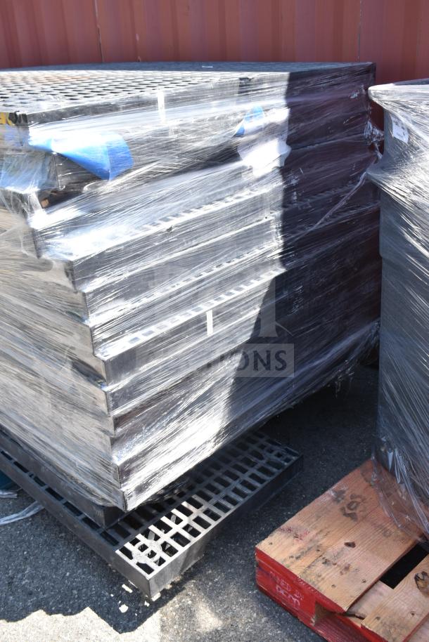 Stack of 32 black poly shelves, shrink-wrapped, on a pallet. Suitable for storage or display.