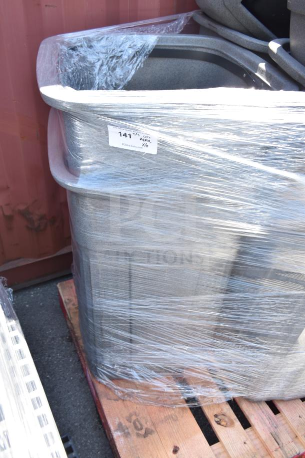 6 gray poly trash cans, wrapped in plastic, stacked on a pallet. Label indicates auction lot of 6.